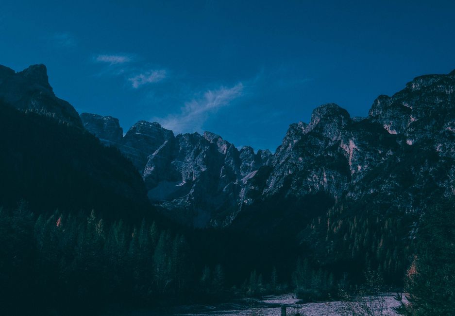 Stunning view of rugged mountains under a vibrant blue sky, perfect for nature exploration enthusiasts.